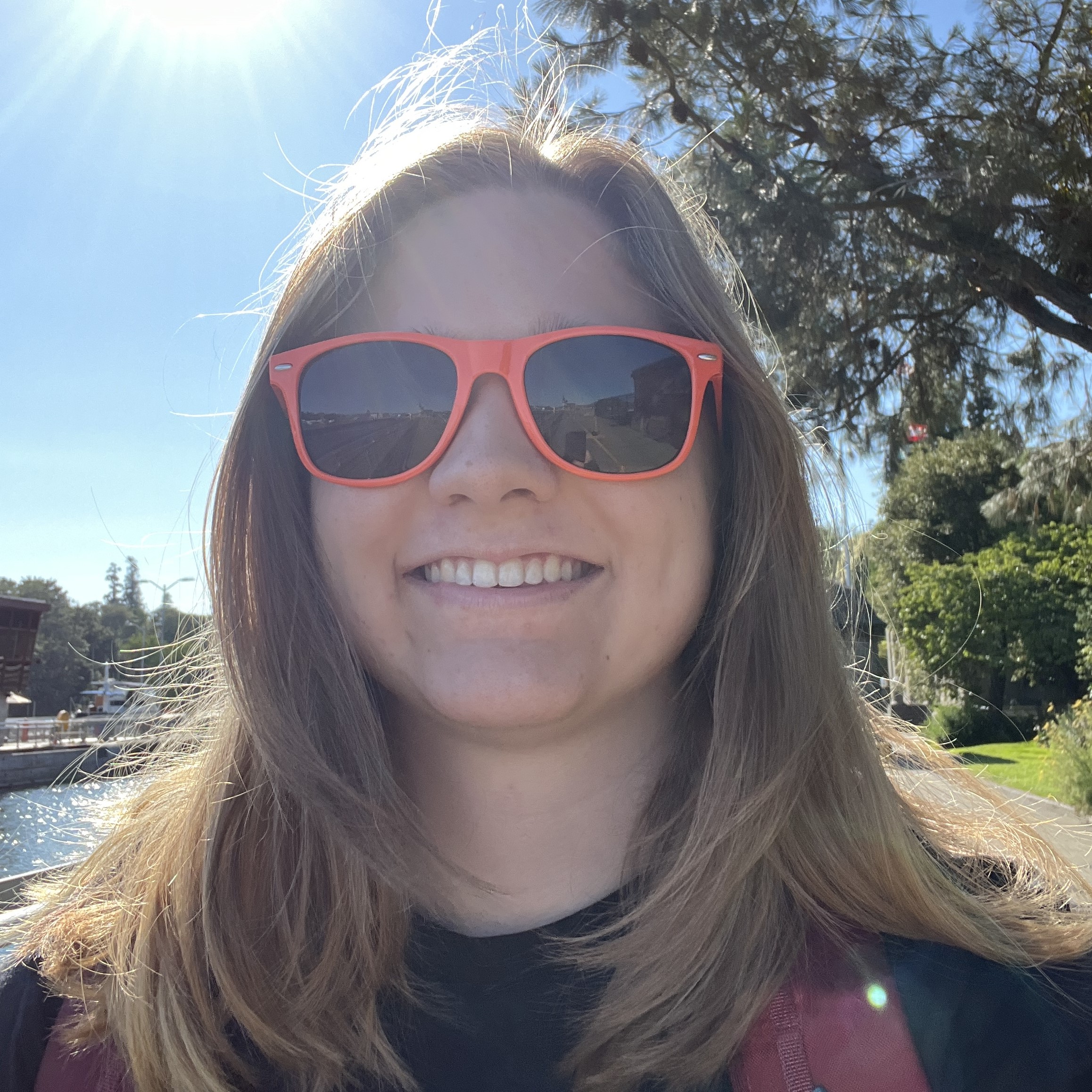 Hannah in orange sunglasses outside