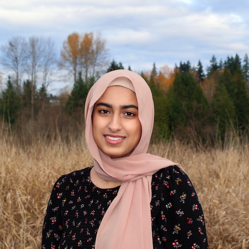 headshot of Hibbah in front of trees