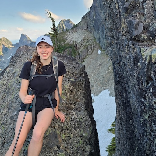 Merav Frank, sitting on a boulder during a hike