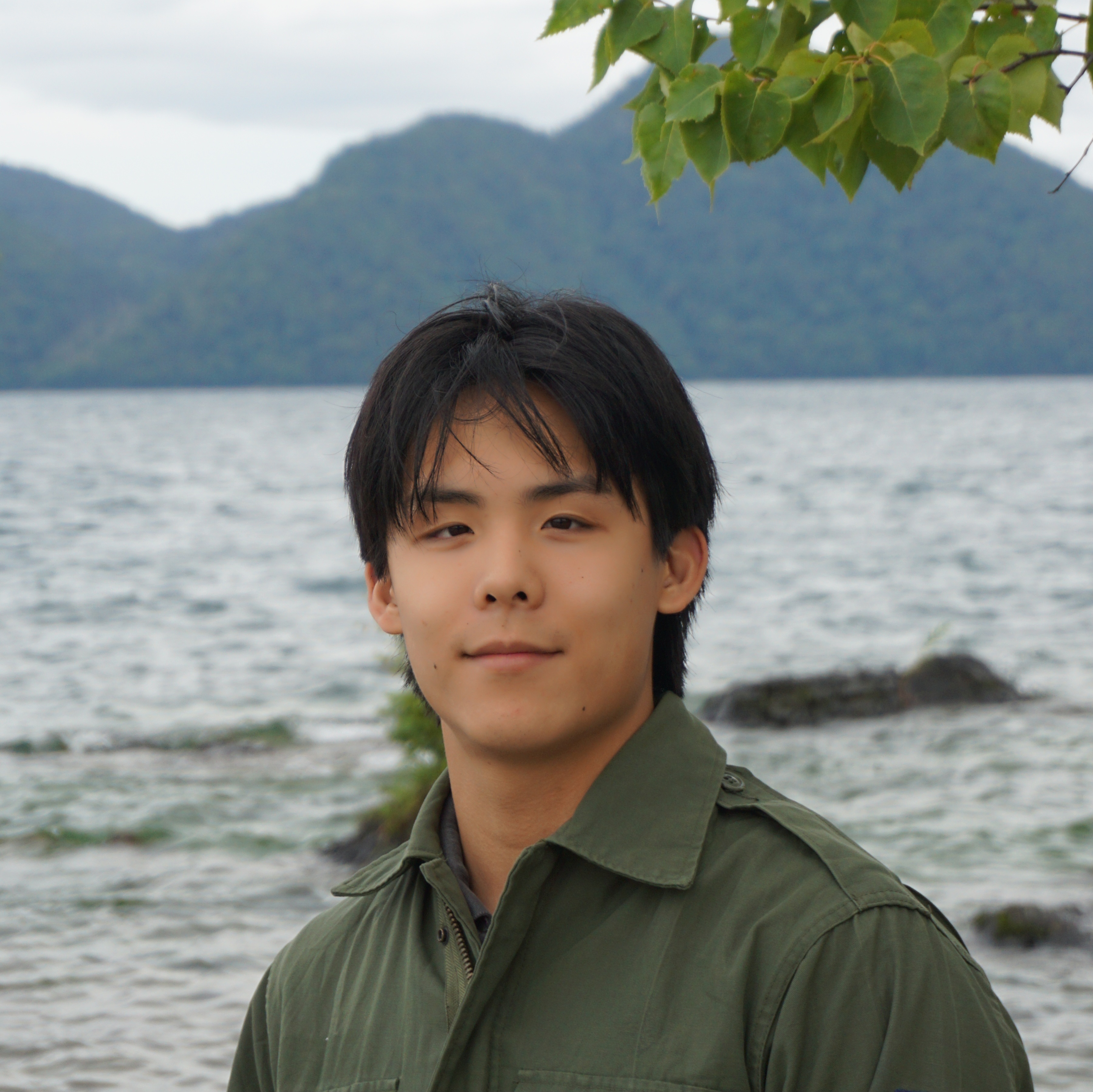 Picture of Cedric Huang standing in front of a lake