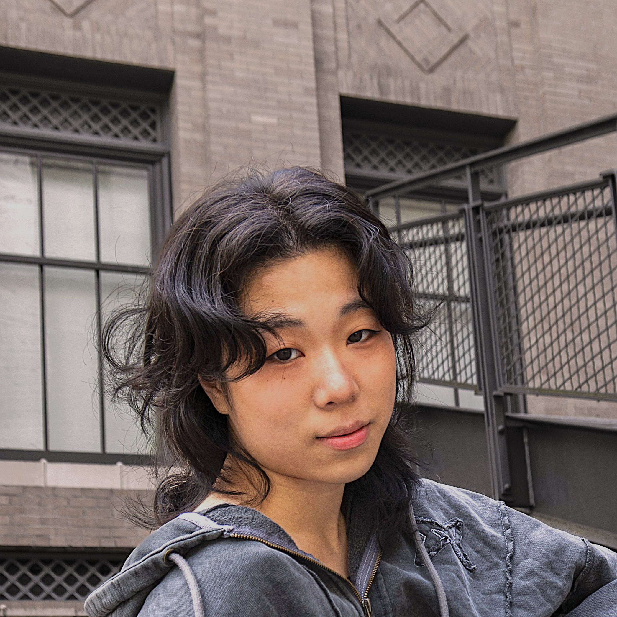 Headshot of Ivy Wang with the UW Architecture building in the background