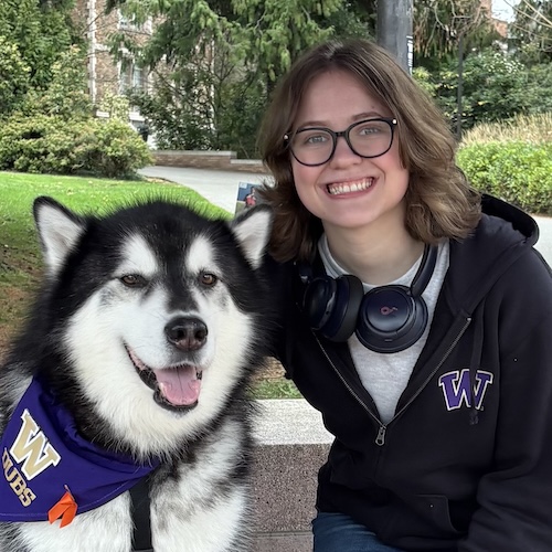 A photo of the TA Tamsyn Henke with the UW mascot Dubs the husky dog.