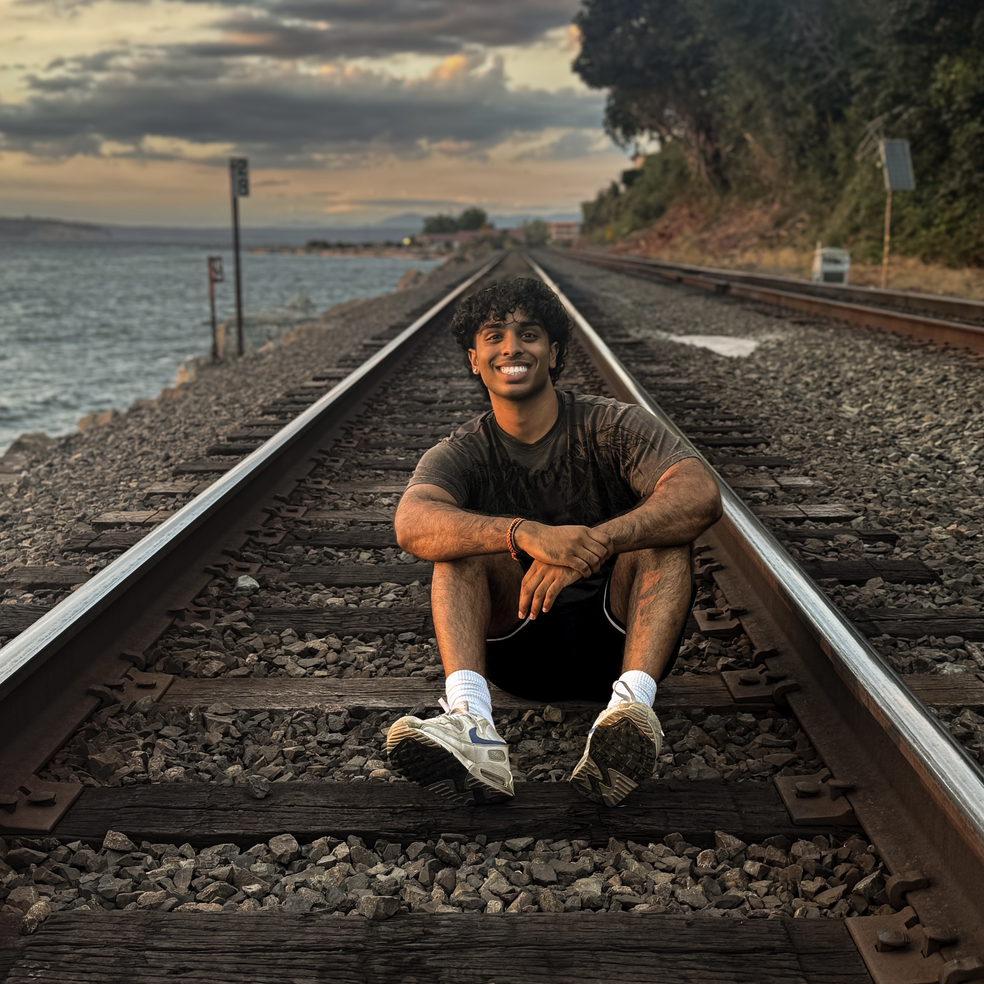 Image of Amogh posing by a shore