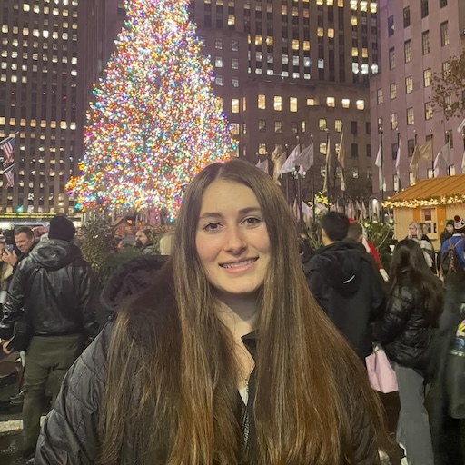 Hannah standing next to a large Christmas tree at Rockefeller Center.