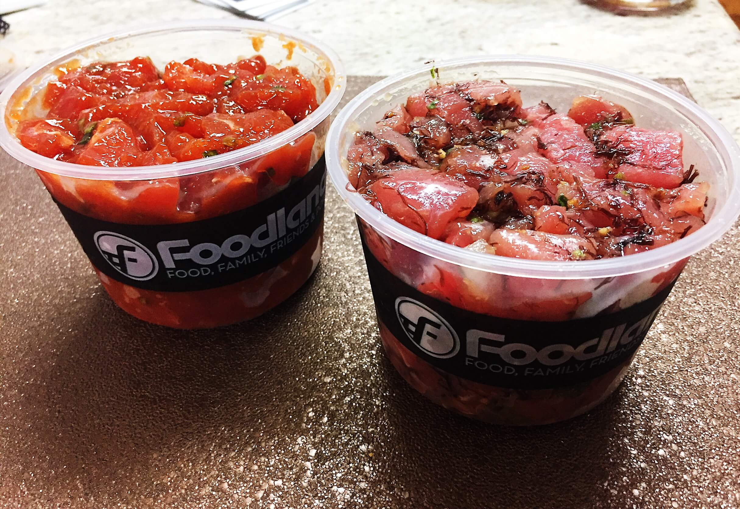 Two bowls of poke: raw fish cut
              into cubes and marinated.