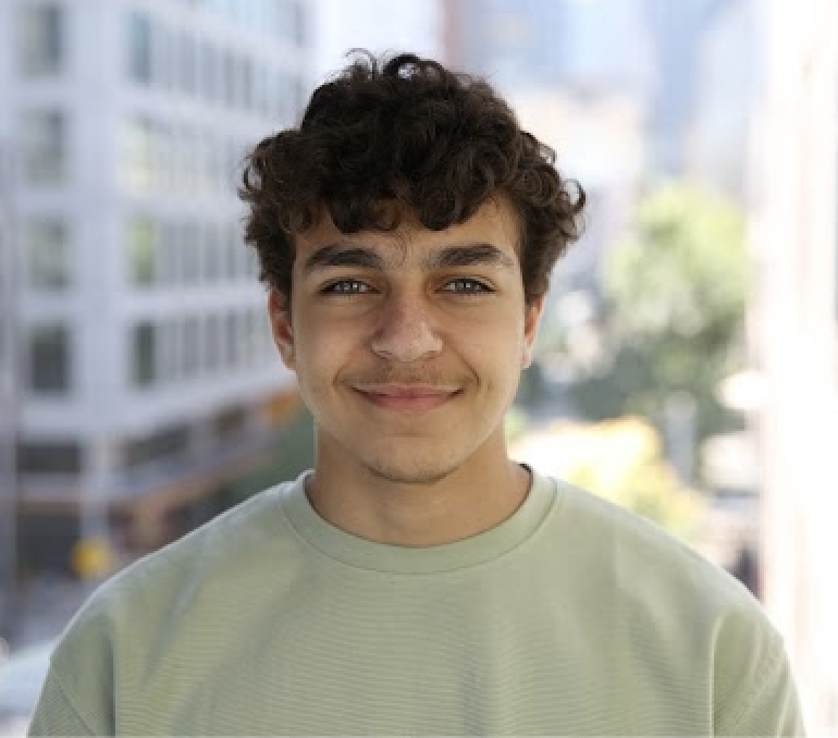 A profile picture of Omar Abdel Aziz, smiling at the camera. He is
            a white man with brown hair wearing a green shirt.