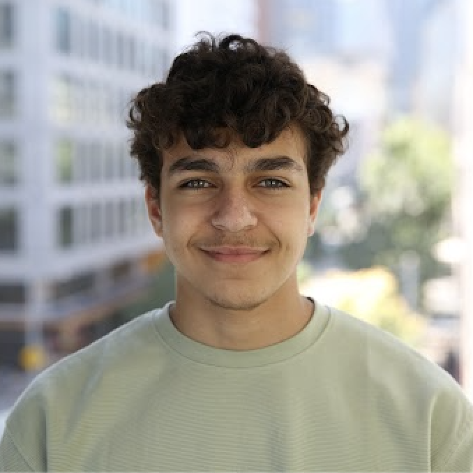 A profile picture of Omar Abdel Aziz, smiling at the camera. He is
    a white man with brown hair wearing a green shirt.