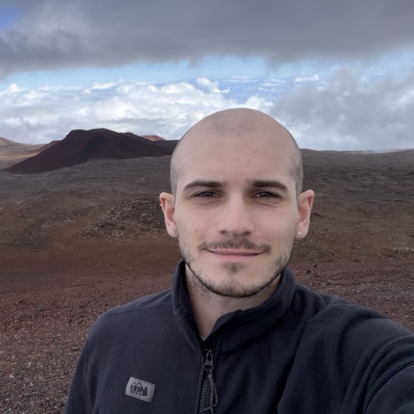 Kyle standing among the clouds at the summit of Mauna Kea.