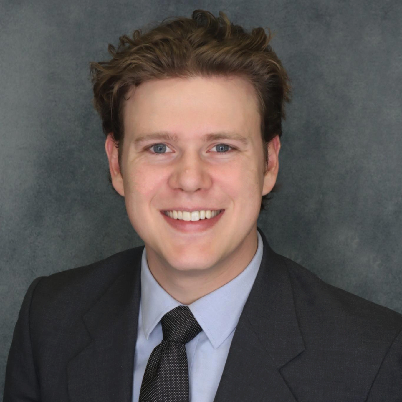 A profile picture of Ethan in a suit.