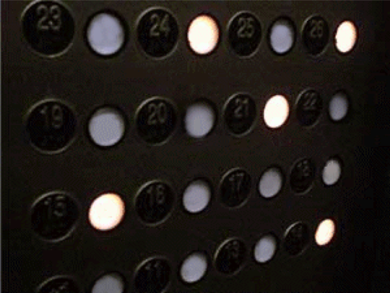 :img Picture of an elevator button panel with the labels and buttons not visually associated leading to ambiguity,40%