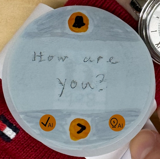 The MindMii paper prototype watch face on a reply screen showing a text 'how are you?'