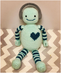 :img A neuro-diverse crochet robot wearing headphones with a big heart, 70%, width