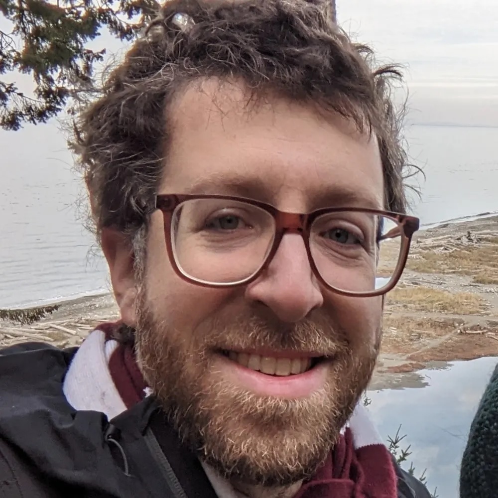 Josh's profile picture, a smiling bearded fella with glasses