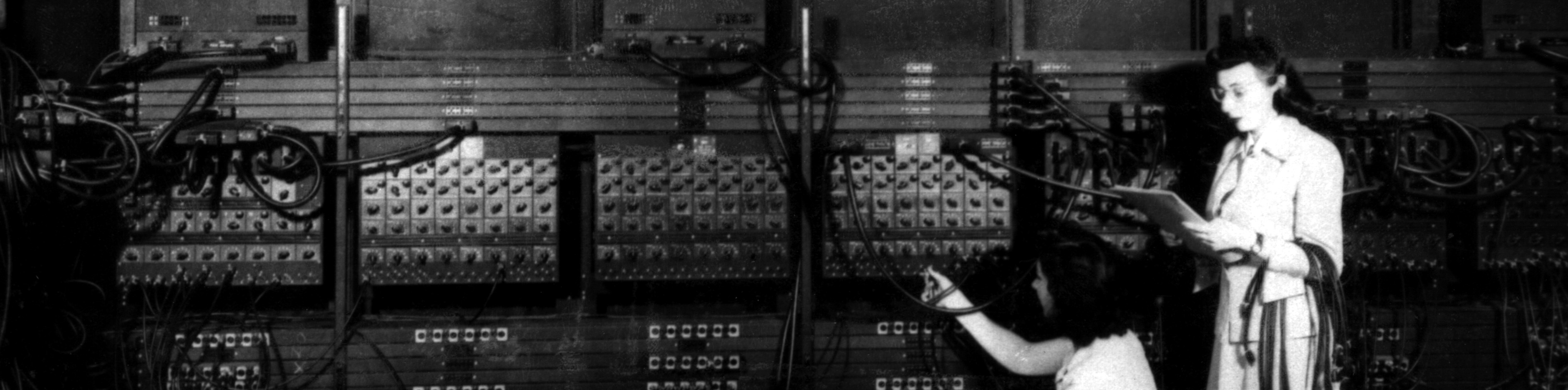 Marlyn Wescoff, standing, and Ruth Lichterman, crouching, wiring the right side of the ENIAC with a new program. Source: U.S. Army/ARL Technical Library Archives